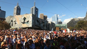 People gather for a vigil at Federation Square, Melbourne, Australia
