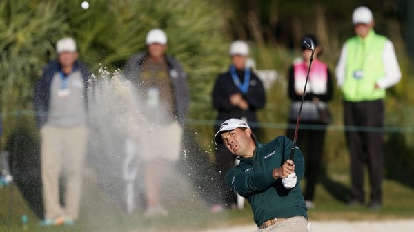 Kevin Kisner hits out of a bunker on the 17th hole