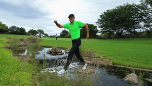 Charl Schwartzel crosses a water hazard at the Alfred Dunhill Championship in South Africa
