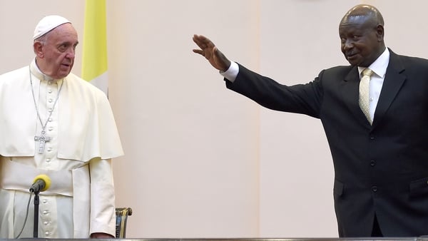 Pope Francis is welcomed by Uganda's president Yoweri Museveni at his arrival in Entebbe, Uganda