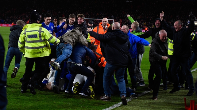 Everton fans invade the pitch after the Toffees take the lead in injury time