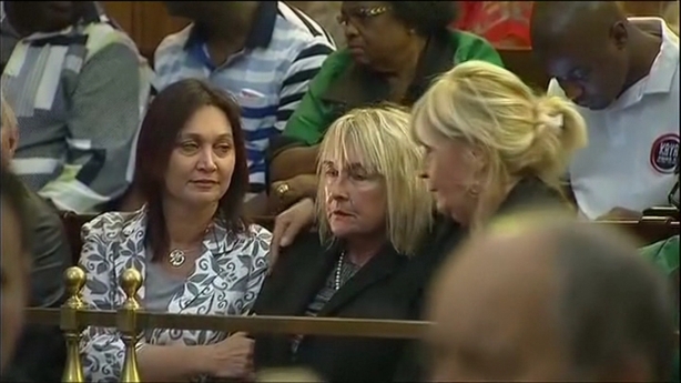 Reeva Steenkamp's mother, June (C), is consoled by friends in court