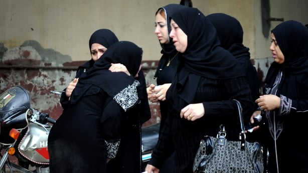 Relatives mourn the dead outside a local hospital
