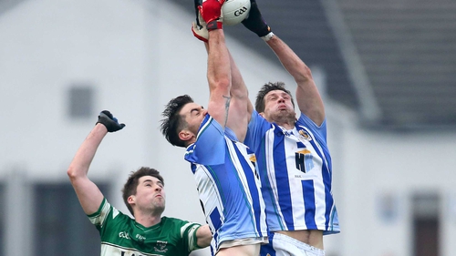 Michael Darragh Macauley and Declan O'Mahony rise for a high ball