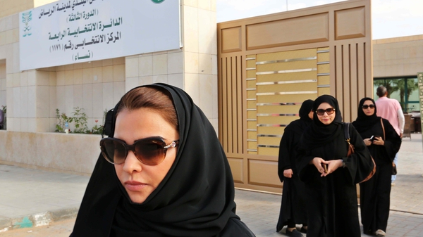 Saudi women leave a polling station after casting their votes in the Kingdom's municipal elections, in Riyadh