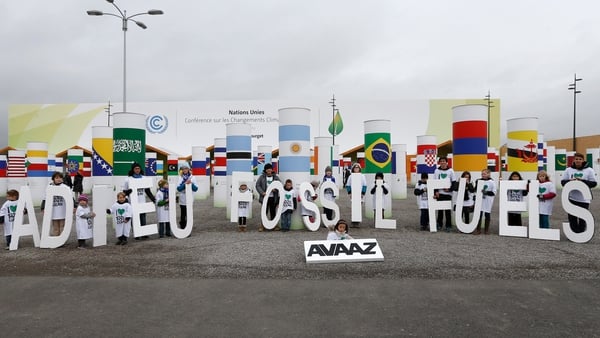 Children take part in a demonstration to promote 100% clean energy during the summit