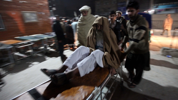 A victim of the 6.3 magnitude earthquake is brought to a hospital in Peshawar, Pakistan