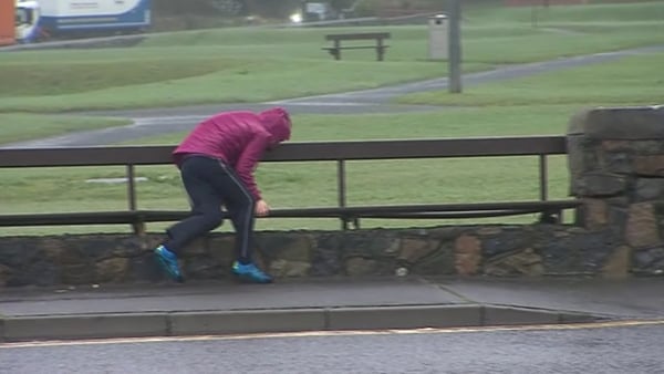 A woman is blown over by the high winds in Galway