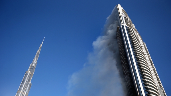Smoke continued to rise from the Address Downtown Hotel today