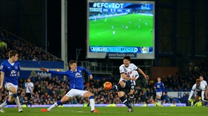John Stones of Everton blocks a shot from Spurs' Heung-Min Son at Goodison Park