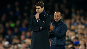 Mauricio Pochettino looks on as Everton boss Roberton Martinez encourages his team in the background