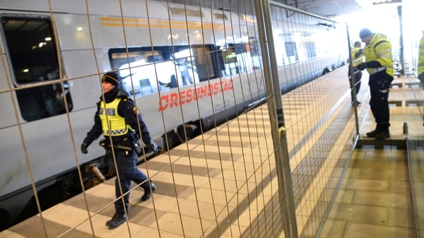Police mount a temporary fence between domestic and international tracks at Hyllie train station in Malmo, Sweden