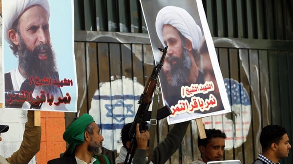 Protestors hold posters of late Shia cleric Nimr al-Nimr, who was executed in Saudi Arabia, during an anti-Saudi protest outside the Saudi embassy in Sanaa today