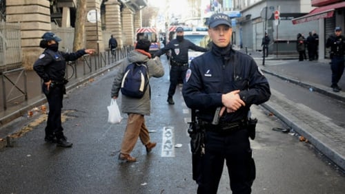 Armed French police patrol near the Boulevard de Barbes in the north of Paris