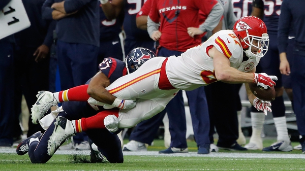 Travis Kelce of the Kansas City Chiefs is tackled by Huston Texans' Quintin Demps