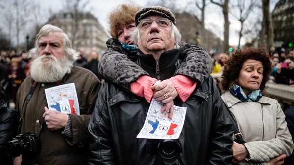 People gather to honour the victims of the terrorist attacks in 2015, at the Place de la Republique in Paris