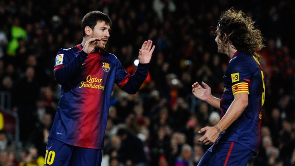 Messi and Puyol together playing for Barcelona before the centre-half retired