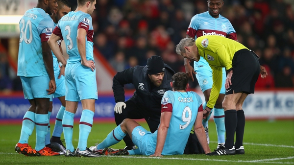 Referee Martin Atkinson stands over an injured Andy Carroll on Tuesday night