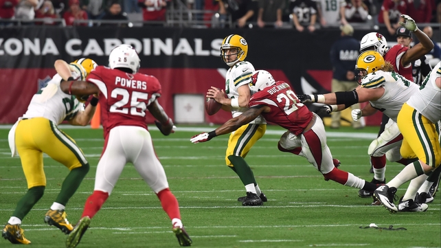 Aaron Rodgers of the Green Bay Packers is sacked by Deone Bucannon of the Arizona Cardinals