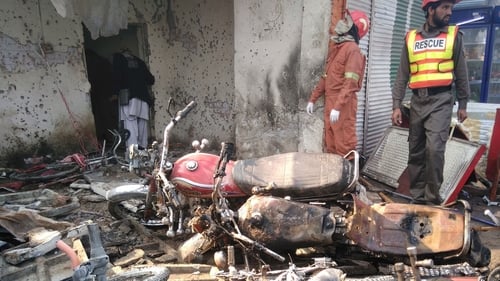 Rescue workers search the site of the suicide bomb attack