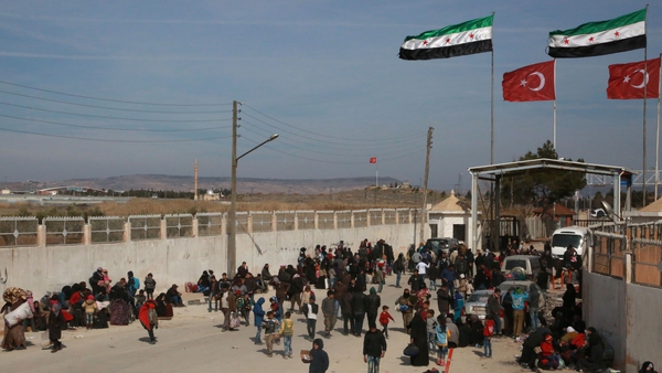 Syrians fleeing the city of Aleppo wait at the Bab al-Salama crossing on the border between Syria and Turkey