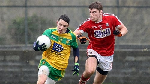 Donegal's Eoin McHugh fends off Ian Maguire of Cork