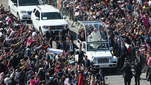 Pope Francis travels in the Popemobile after a welcome ceremony at the National Palace in Mexico City