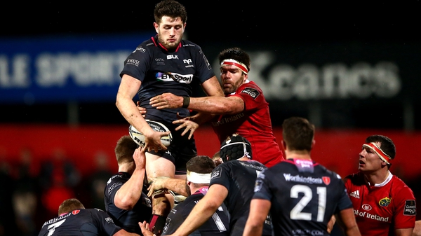 Ospreys' Rory Thornton and Billy Holland of Munster rise in battle for possession