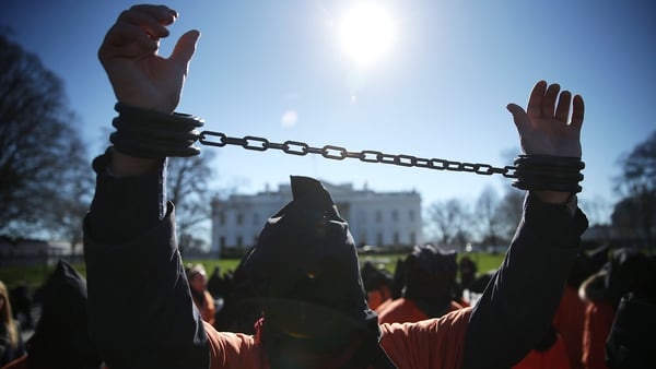A demonstrator in an orange jumpsuit participates in a rally in front of the White House to demand the closure of Guantnamo Bay last month
