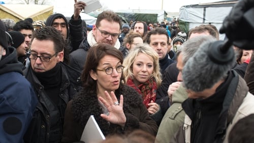 Judge Valerie Quemener was mobbed by journalists and migrants as she made her way round the site