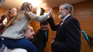 Gerry Adams of Sinn Fein is high-fived by a young supporter at the constituency count in Dundalk