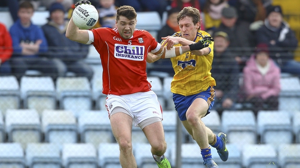 Cork's Tomas Clancy under pressure from Roscommon's Conor Devaney at Pairc Ui Rinn