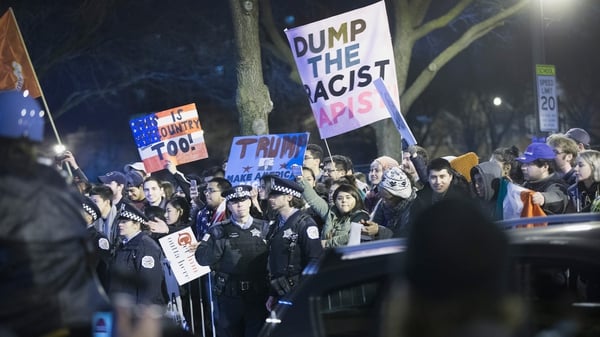 Demonstrators taunt supporters of Republican presidential candidate Donald Trump