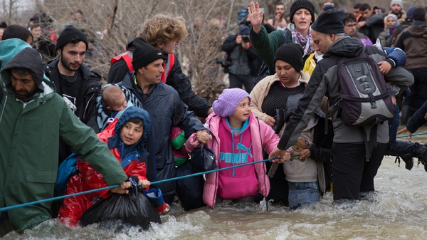 The people used a rope to help them cross a swollen river