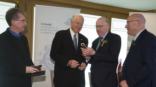 Prof Séamus Davis and Dr Craig Barrett are presented with their medal by the Minister for Foreign Affairs and SFI Director General