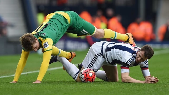 Norwich's Patrick Bamford and Jonny Evans of West Brom get into a tangle