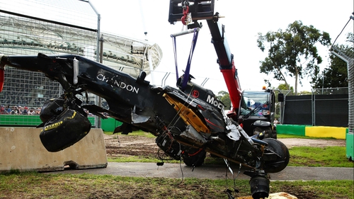 The wreck of Fernando Alonso's McLaren Honda is retrieved
