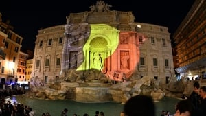 A Belgian flag is displayed on the Trevi Fountain in Rome