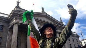 A woman dressed as Countess Markievicz takes a selfie outside the GPO