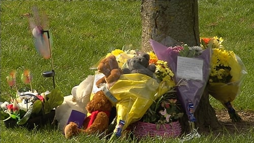 Flowers and toys left near where the bodies were discovered