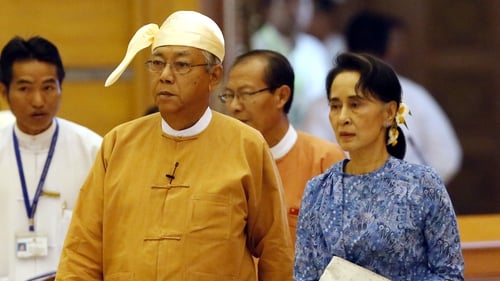 Myanmar's new president Htin Kyaw (L) and democracy leader Aung San Suu Kyi arrive at the parliament