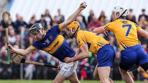 Clare's Cian Dillon and Conor Cleary tackle John McGrath of Tipperary