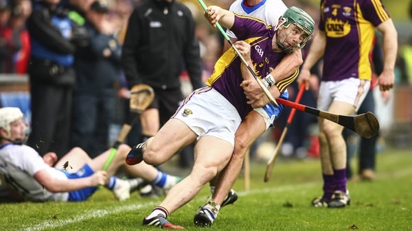 Harry Kehoe of Wexford keeps the ball in play despite Waterford pressure