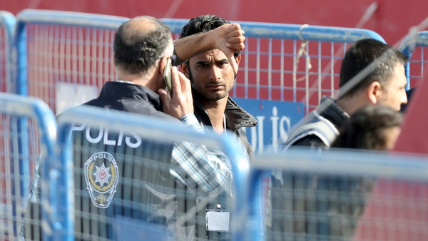 A man deported to Turkey under the deal gives a 'thumbs-down' gesture