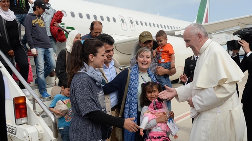 Pope Francis welcomes the group of Syrian refugees that flew with him after landing at Ciampino airport in Rome this afternoon