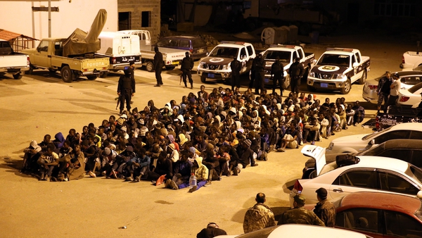 Migrants are stopped from attempting a Mediterranean crossing after a police raid on their hideout in Tripoli, Libya
