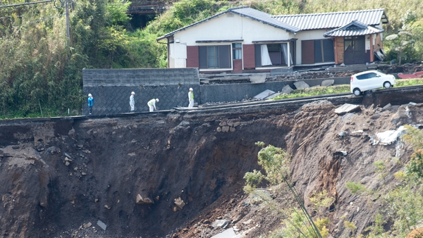 A house teeters on a mountainside following a major landslide caused by the earthquakes in Kumamoto