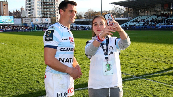 Caster poses with a young fan following a Racing 92 match