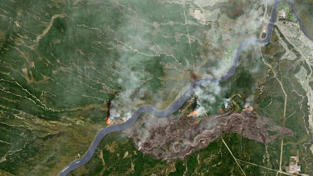 A NASA image combines shortwave infrared, near infrared, and green light of destructive wildfires