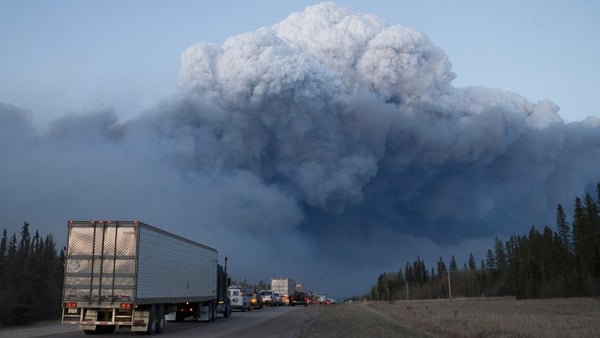 Drivers wait for clearance to take firefighting supplies into town on outside of Fort McMurray